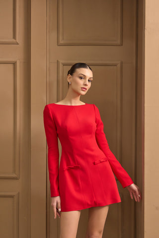 Graceful long-sleeve mini dress with a sculpted fit, soft crepe fabric, and chic bow accents at the hips for a statement touch.