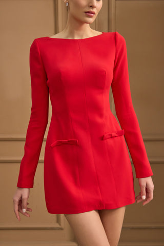 Sophisticated long-sleeve mini dress featuring a tailored sheath silhouette and statement bows at the hips for a touch of charm.