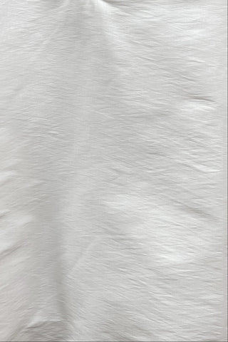 Close-up of a textured white fabric surface
