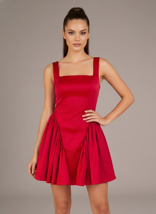 Red dress worn by a model on a plain background