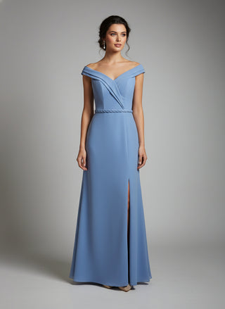 Woman wearing a blue off-shoulder gown on a gray background