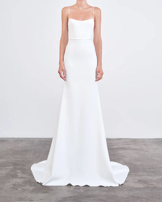 The 'Jane' gown by Alex Perry is a refined white mermaid-style dress featuring delicate spaghetti straps and an elegant train, perfect for weddings