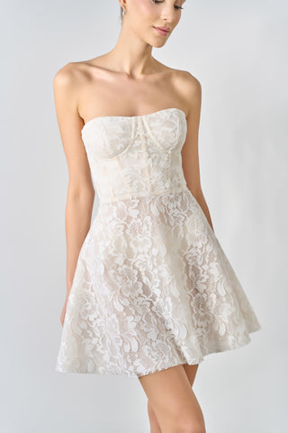 White lace strapless dress on a plain background