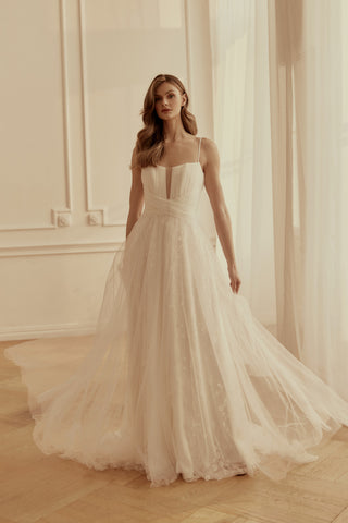 Mia Lavi couture A-line bridal gown in shimmering lace and tulle, showcasing artisanal draping and couture craftsmanship