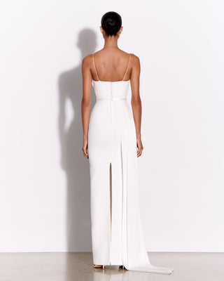 Back view of the Margot wedding dress by Alex Perry, featuring a fitted silhouette with thin straps, button detailing, and a center back split. The gown is floor-length with an elegant train, set against a white background.