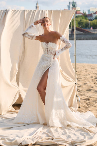 Mia Lavi couture wedding gown featuring hand-applied floral lace, off-shoulder corset bodice, and artisanal European craftsmanship