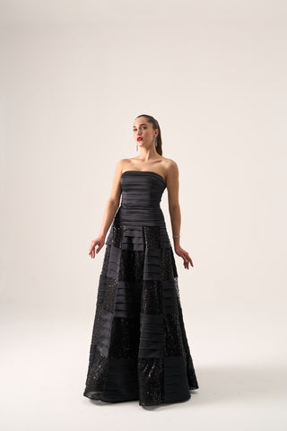 Luxurious ball gown showcasing a strapless design, flared silhouette, and intricate tiered accents, perfect for elegant formal events.