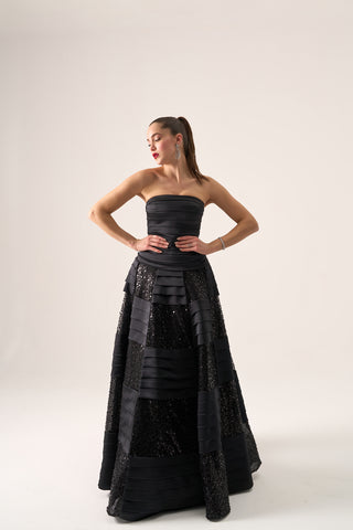 Strapless ball gown with a structured bodice, elegantly flared silhouette, and intricate tiered detailing for formal occasions.