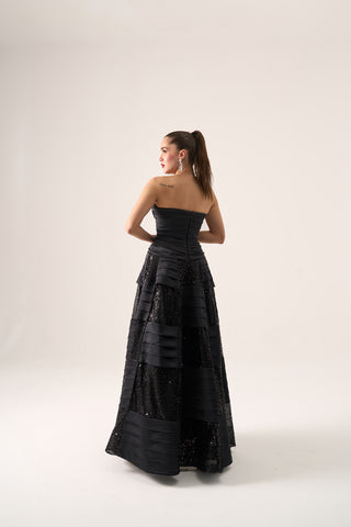 Sophisticated evening dress featuring a strapless neckline, sleeveless design, and floor-length flared ball gown silhouette.