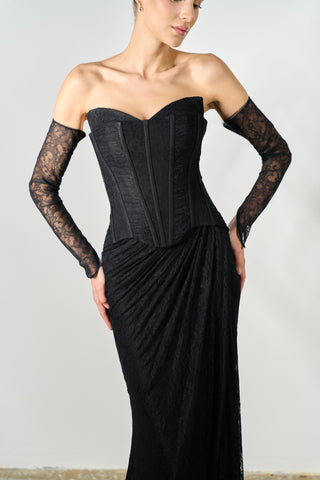 Black strapless gown with lace sleeves on a plain background