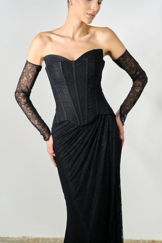Black strapless gown with lace sleeves on a plain background