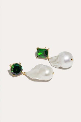 Exclusive designer earrings with an asymmetric silhouette, combining pearls and zirconia in a refined setting.