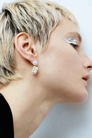 Luxurious statement earrings showcasing a dynamic, modern silhouette with polished semi-precious stones and intricate detailing.