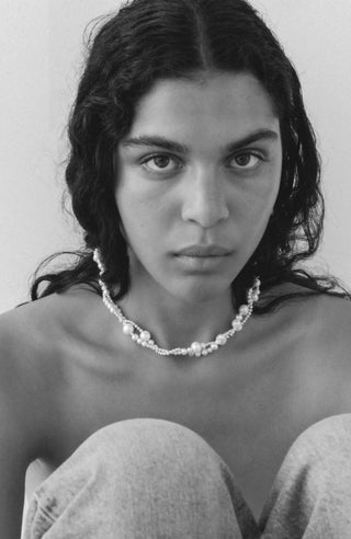 Designer necklace with an asymmetric pearl composition, highlighting a modern, artful aesthetic and intricate handcrafted detailing.