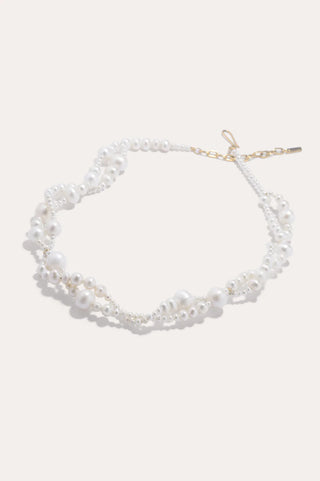 Luxury necklace featuring delicate freshwater pearls arranged along a sculpted chain, a signature Completedworks statement piece.