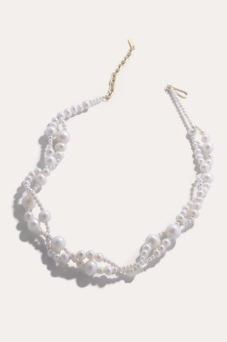 Sophisticated pearl necklace with fluid contours and a sculptural finish, designed for effortless elegance and high-fashion styling.
