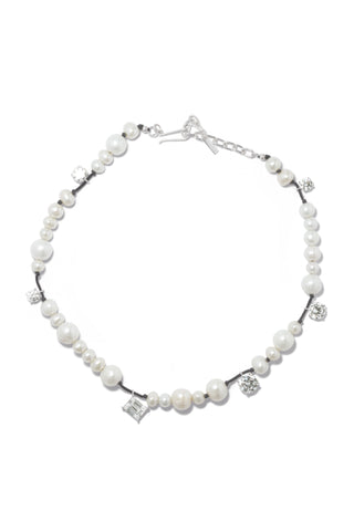 Sculptural freshwater pearl necklace with hand-set cubic zirconia, intricately woven on a delicate braided cord and anchored by recycled silver.