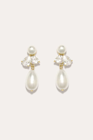 Elegant drop earrings featuring smooth pearls and sparkling zirconia in a modern design.