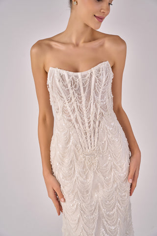 White strapless beaded dress on a plain background
