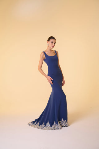 Sophisticated mermaid gown with a scoop neckline, sleeveless design, and intricately embellished hemline for formal events.