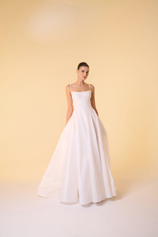 Luxury bridal gown showcasing a scoop neckline and flowing skirt for a timeless, refined look