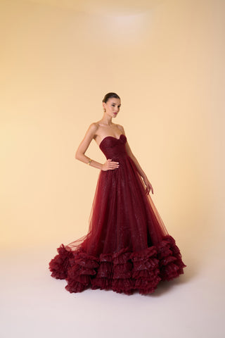 Luxury evening dress featuring a strapless sweetheart neckline, tulle fabric, and layered ruffled hemline for added drama