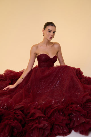 Formal evening gown showcasing a fitted bodice, voluminous skirt, and shimmering tulle with elegant ruffled accents