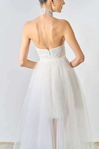 White strapless dress with lace detailing on a plain background