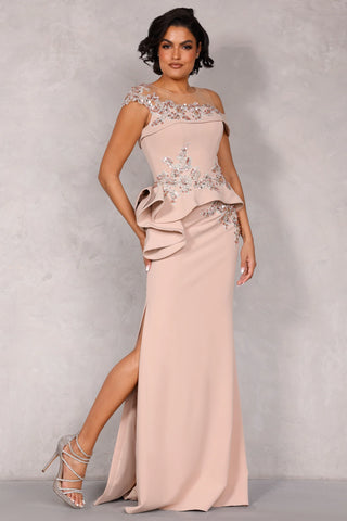 Sheath evening gown with illusion neckline, sleeveless cut, and dramatic peplum detail