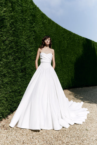 Statement strapless gown with a structured Mikado A-line silhouette and an elegantly designed sweeping train.