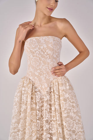 Beige strapless lace dress worn by a model on a plain background