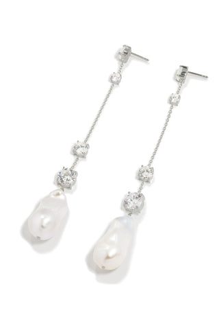 Luxury statement earrings with sculptural baroque pearls and shimmering zirconia accents, crafted in ethically sourced recycled silver.