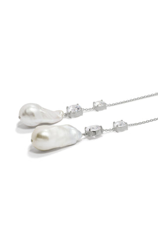 Sophisticated drop earrings with brilliant zirconia stones and sculptural baroque pearls, elegantly set on delicate recycled silver chains.