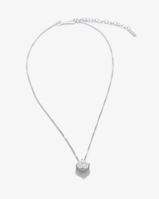 Luxury designer necklace with a sculptural silhouette, showcasing a suspended zirconia pendant on an elegantly refined silver chain