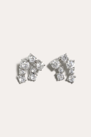 Sculptural earrings with cascading cubic zirconia stones set in rhodium-plated silver, creating fluid movement.