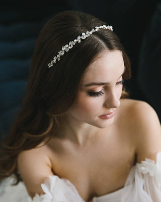 Woman wearing a decorative headband with a dark background