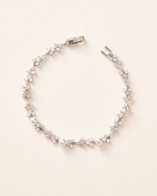 Silver bracelet with clear stones on a beige background
