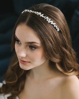 Woman wearing a decorative headband with a dark background