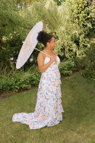 Woman in a floral dress in a garden setting