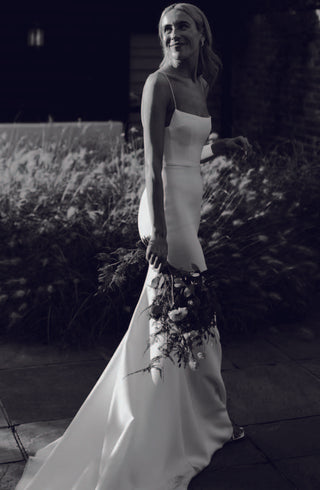 The Alex Perry 'Jane' gown looks effortlessly chic as a bride wears it on her wedding day. The elegant mermaid silhouette is accentuated by an extended train