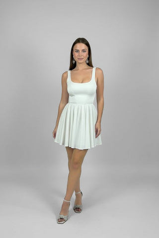 Woman wearing a white dress on a gray background
