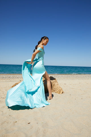 Designer evening dress showcasing a corseted satin bodice with ruched accents and delicate spaghetti straps.