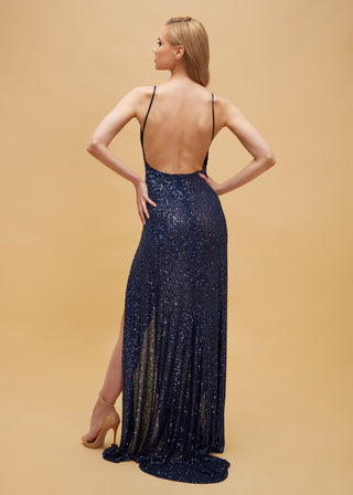 Designer column gown with dual slits, delicate straps, and shimmering accents, perfect for formal occasions.