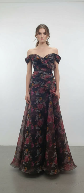 Woman wearing a floral off-shoulder evening gown against a white background