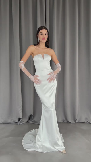 Elegant strapless wedding dress with a form-fitting sheath silhouette and smooth satin fabric