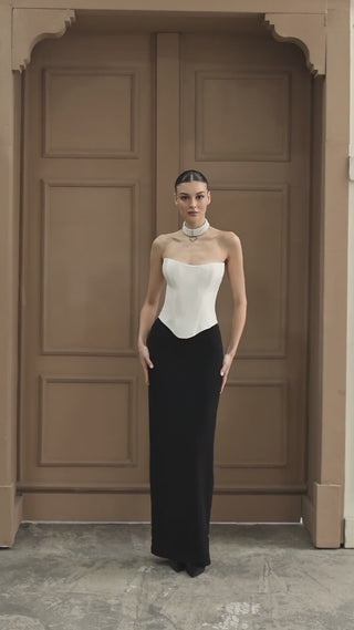 Luxurious bridal ensemble with a structured strapless bodice and figure-enhancing skirt, designed for a timeless wedding aesthetic.