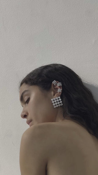 Exquisite statement earrings with a refined, sculptural shape, highlighted by clustered cubic zirconias set in rhodium-plated recycled silver.