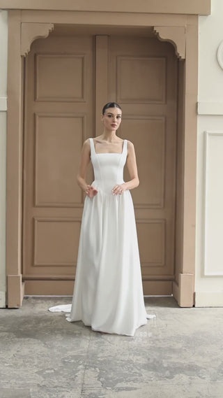 Elegant A-line bridal gown with a corset bodice and soft, flowing fabric designed for a graceful, refined wedding day style.