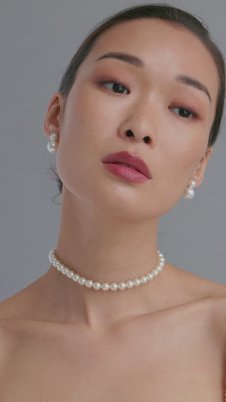 Model demonstrating the Pearl Ribbon Tie worn as a choker necklace, adding elegance to her outfit.