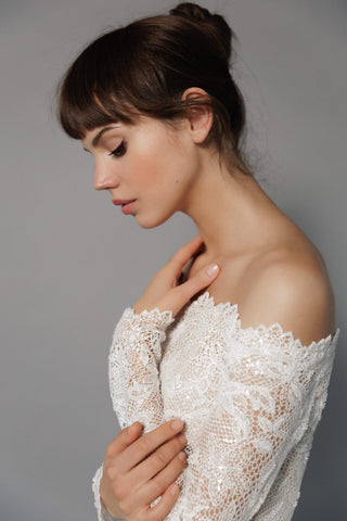 Daalarna couture bridal creation with off-shoulder neckline, artisanal beading, and luxury made-to-order craftsmanship